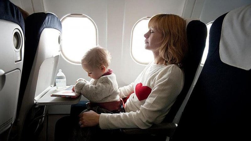 Baby and mother at an airplane